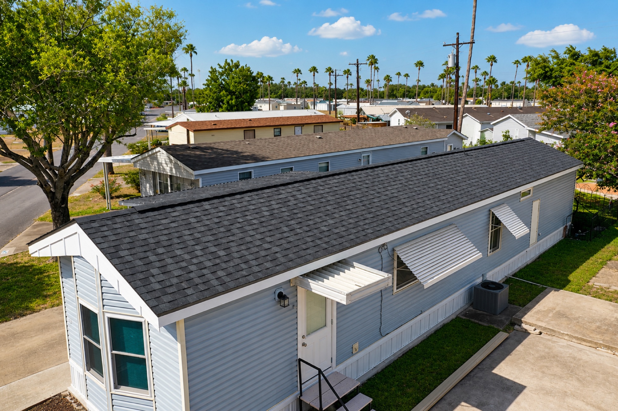 Completed charcoal architectural shingle roof replacement on a mobile home in the Rio Grande Valley